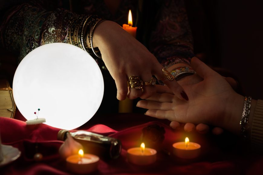 Gypsy woman fortune teller read a fortune from palm